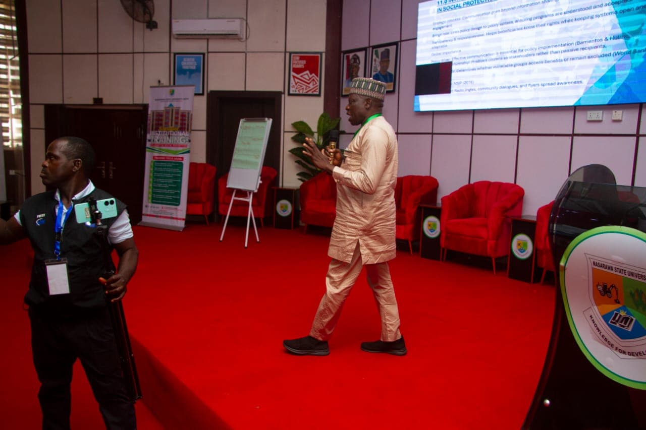 A presenter addressing participants during a university institutional session
