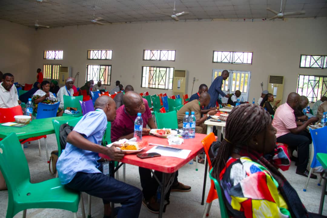 Participants working together around tables during an institutional learning session